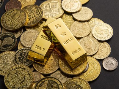 Coins, and gold bars scattered on a table